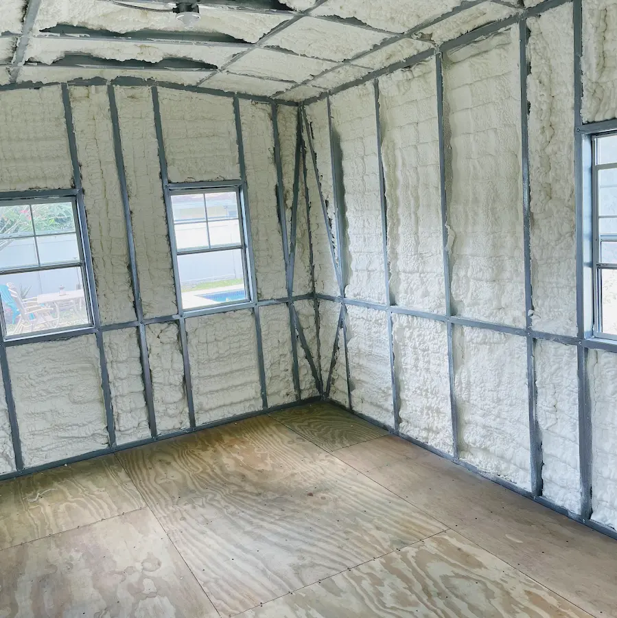 Closed-cell spray foam insulation applied to wall cavities in a residential project in Le Roy